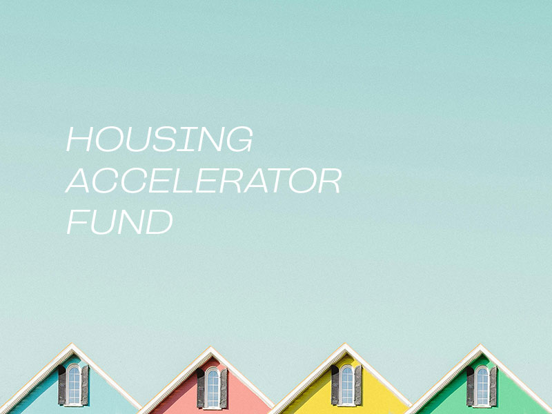 tops of four colourful houses with text that reads "housing accelerator fund"