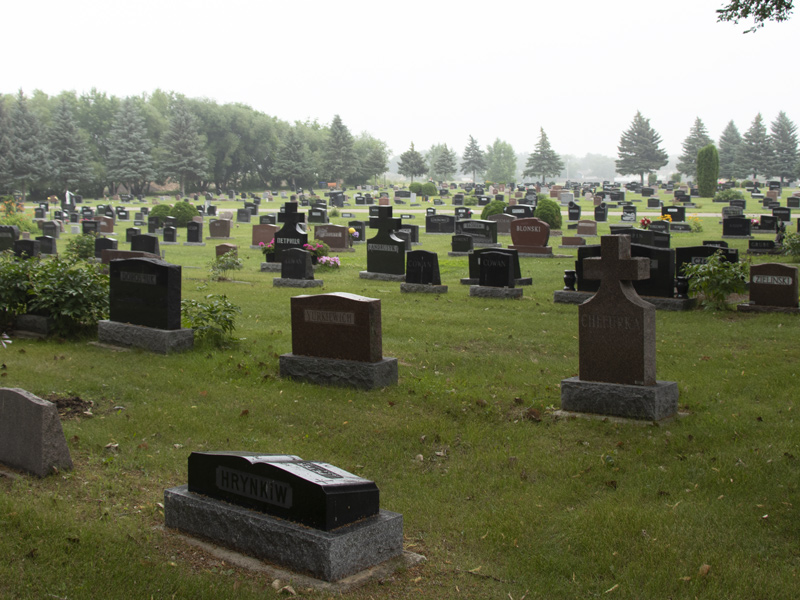 row of head stones in cemetery