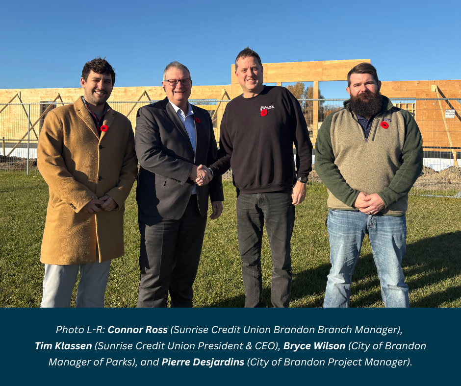 Photo of folks standing outside the construction of the Sunrise Credit Union Clubhouse